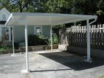 freestanding patio cover in a parking lot to park under