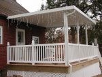patio covers over raised deck with railing and lights